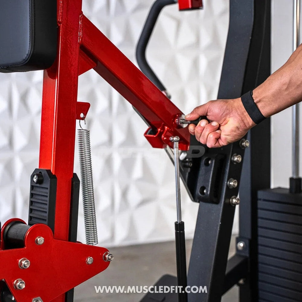 Close-up of a hand adjusting a red seated row gym machine with weights and spring mechanism.